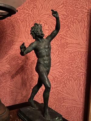 [bronze sculpture: nude figure with beard and long hair]
