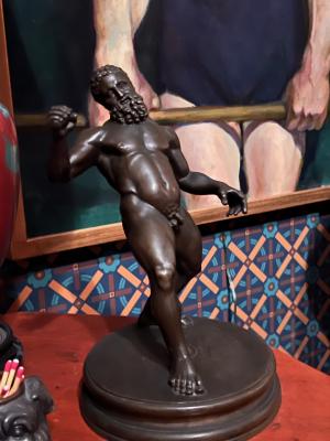 [bronze sculpture: nude male leaning back]