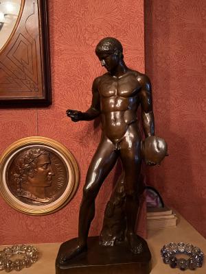 [bronze sculpture: nude male discus thrower]